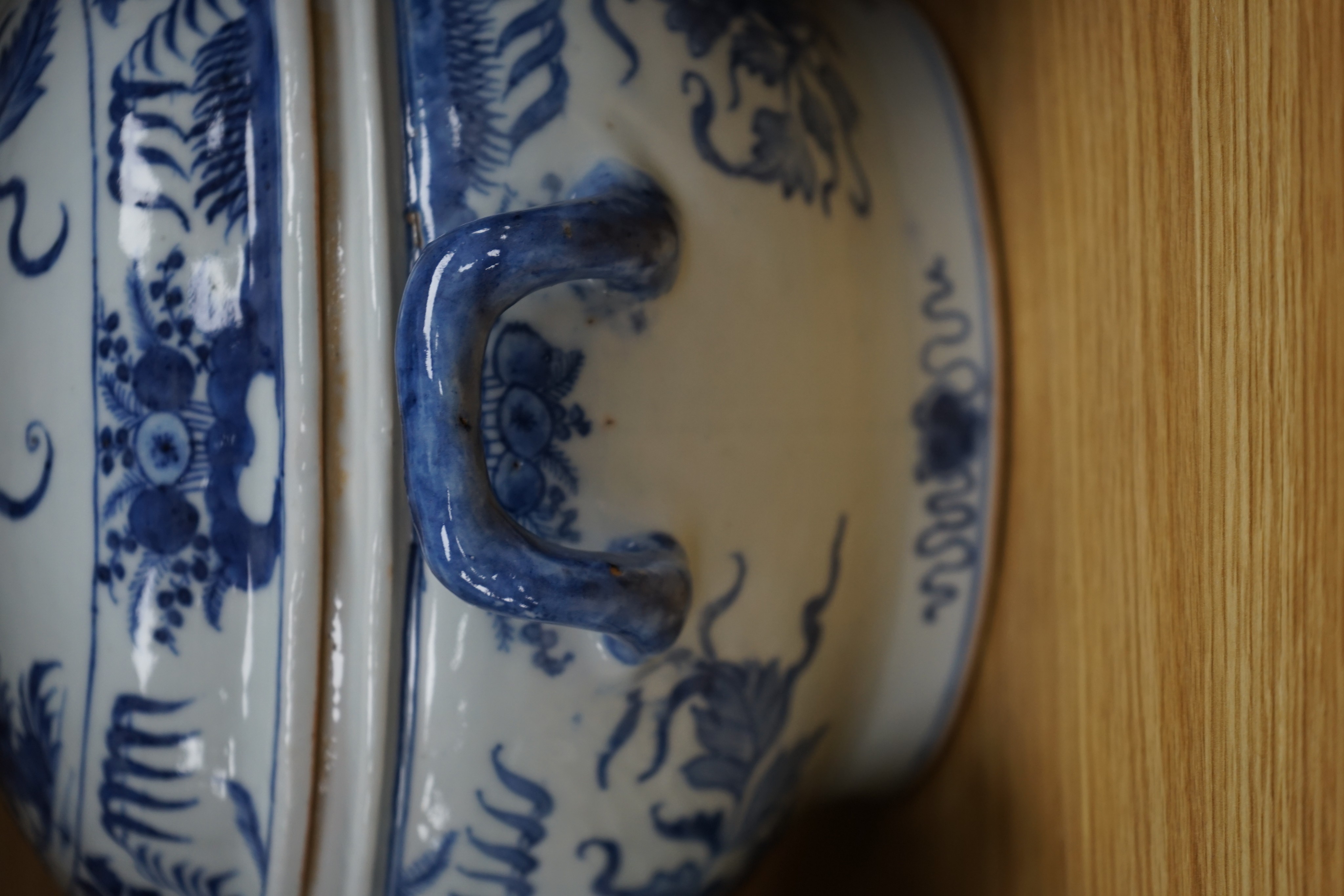 An 18th century Chinese Export blue and white octagonal tureen and cover, decorated with birds and flowers, a pair of similar sauceboats and five plates decorated with urns of flowers